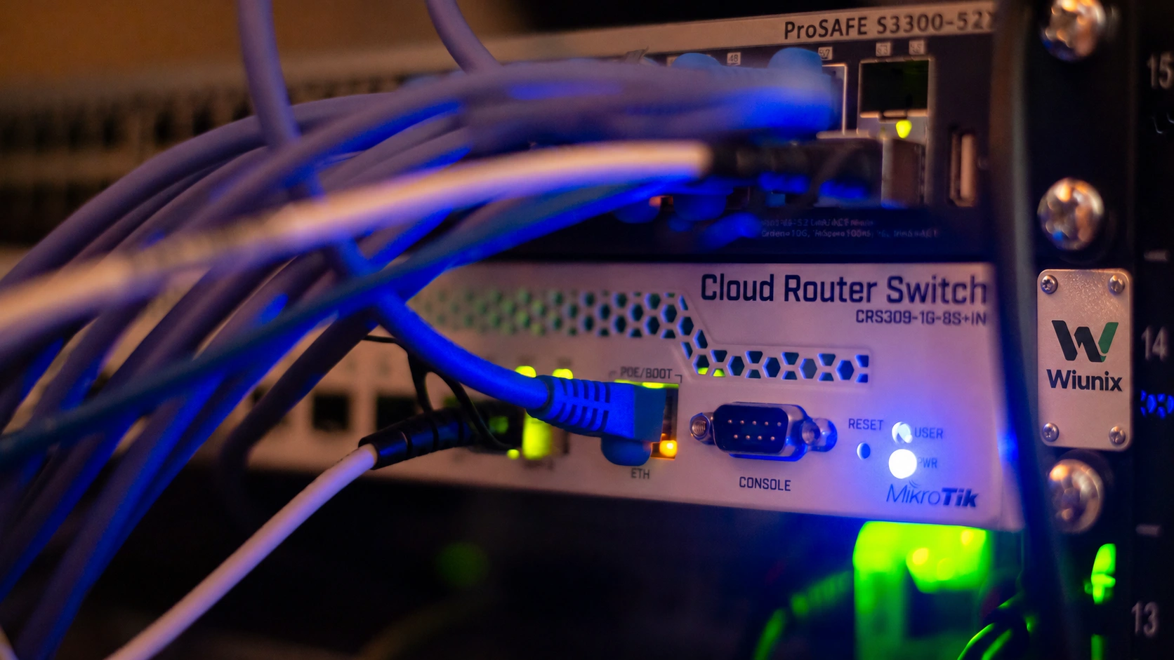 Network routers and Ethernet connections with an illustrative Wiunix rack identification plaque